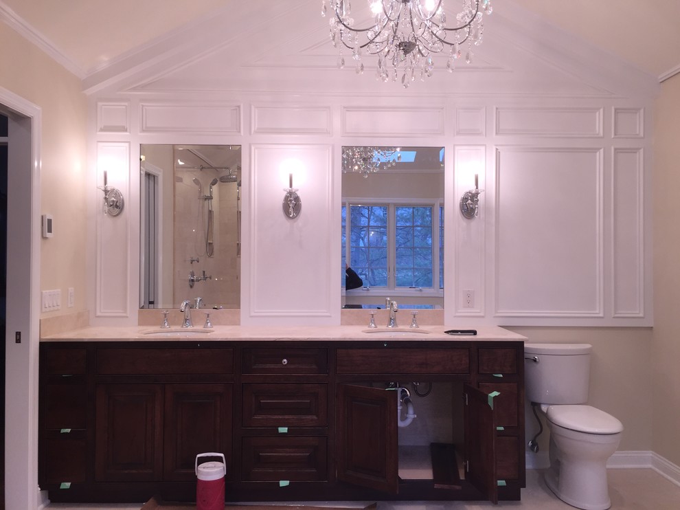 Mid-sized elegant master bathroom photo in New York with an undermount sink, recessed-panel cabinets, dark wood cabinets, a one-piece toilet and beige walls