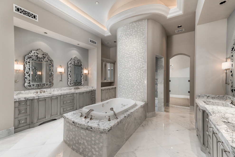 Huge tuscan master multicolored tile and mosaic tile marble floor and gray floor bathroom photo in Phoenix with furniture-like cabinets, gray cabinets, a one-piece toilet, beige walls, a drop-in sink and marble countertops