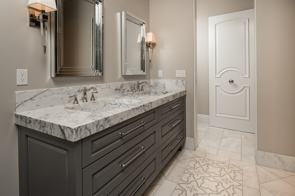 This is an example of an expansive mediterranean ensuite bathroom in Phoenix with raised-panel cabinets, grey cabinets, a built-in bath, a walk-in shower, a one-piece toilet, multi-coloured tiles, marble tiles, beige walls, marble flooring, an integrated sink, marble worktops, multi-coloured floors, an open shower, multi-coloured worktops, double sinks, a built in vanity unit, a coffered ceiling and panelled walls.