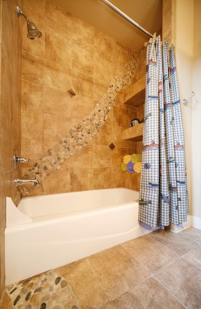Inspiration for a medium sized classic family bathroom in Austin with an alcove bath, beige walls, raised-panel cabinets, medium wood cabinets, a shower/bath combination, stone tiles, travertine flooring and solid surface worktops.