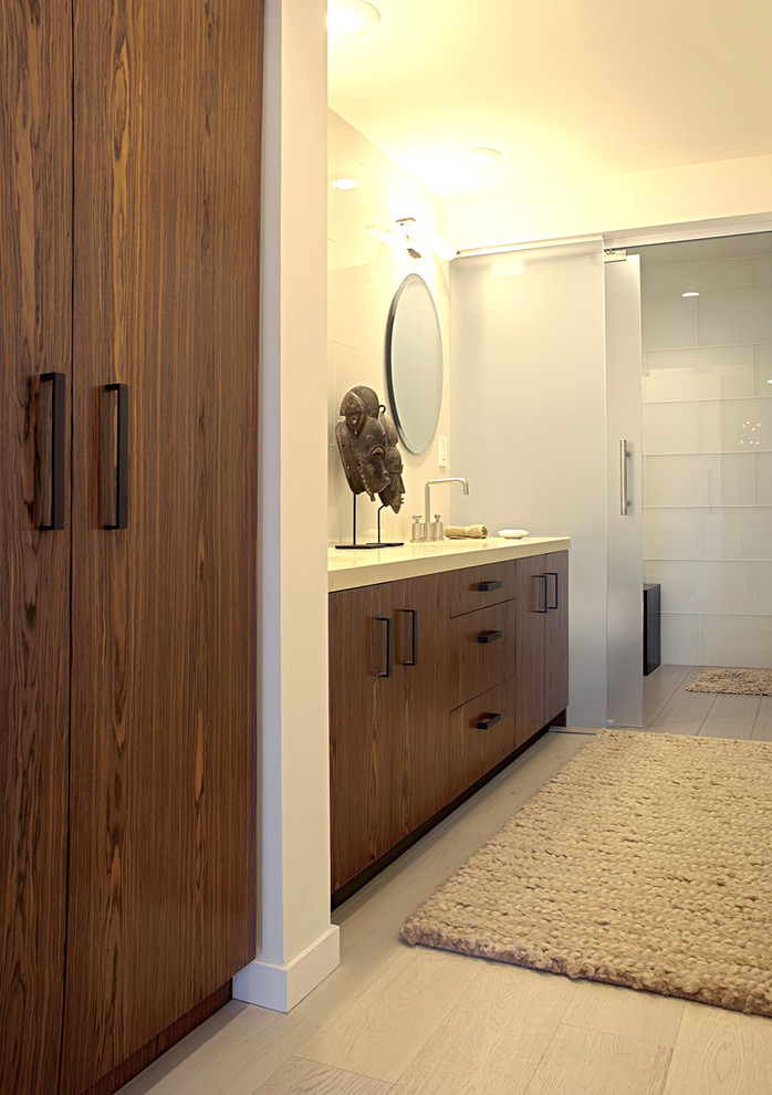 Contemporary bathroom in San Francisco with flat-panel cabinets, dark wood cabinets and an alcove shower.