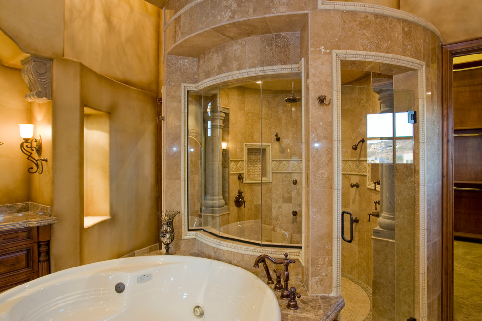 Cette image montre une très grande salle de bain principale méditerranéenne en bois foncé avec un placard avec porte à panneau surélevé, une baignoire posée, une douche d'angle, un carrelage beige, un carrelage blanc, un carrelage de pierre, un mur beige et un plan de toilette en granite.
