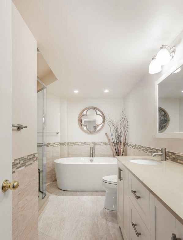 Bathroom - large transitional master beige tile porcelain tile bathroom idea in Ottawa with an undermount sink, shaker cabinets, white cabinets, quartz countertops, a one-piece toilet and beige walls