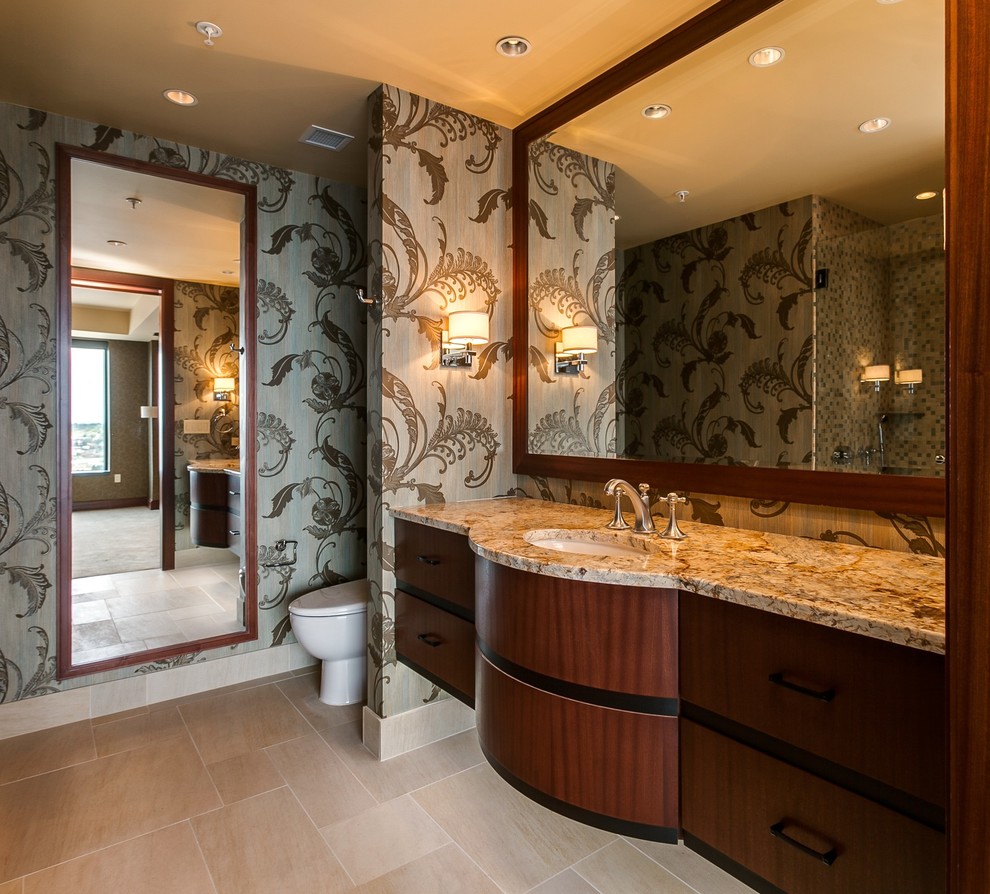 This is an example of a medium sized traditional sauna bathroom in Denver with freestanding cabinets, light wood cabinets, granite worktops, beige tiles, stone tiles, a two-piece toilet, a submerged sink, beige walls and travertine flooring.