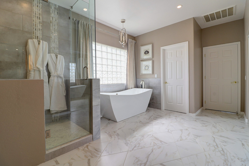 Mid-sized transitional master beige tile and porcelain tile porcelain tile, white floor and double-sink bathroom photo in Phoenix with raised-panel cabinets, gray cabinets, a two-piece toilet, beige walls, an undermount sink, quartz countertops, a hinged shower door, white countertops and a built-in vanity