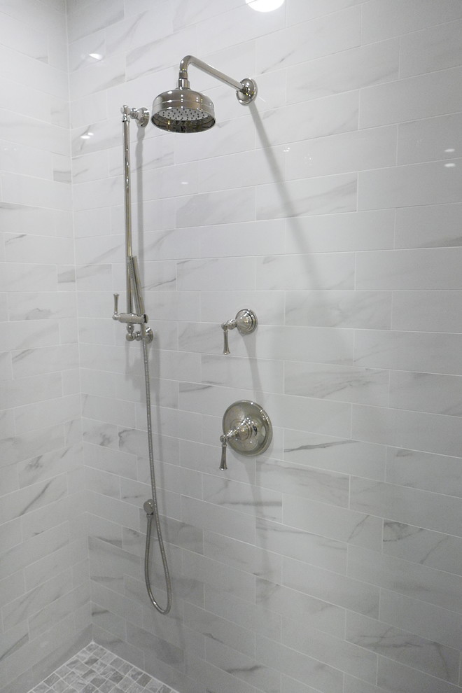 Photo of a large classic ensuite bathroom in Other with shaker cabinets, white cabinets, a freestanding bath, a corner shower, a two-piece toilet, white tiles, porcelain tiles, beige walls, porcelain flooring, a submerged sink, marble worktops, white floors, a hinged door and white worktops.