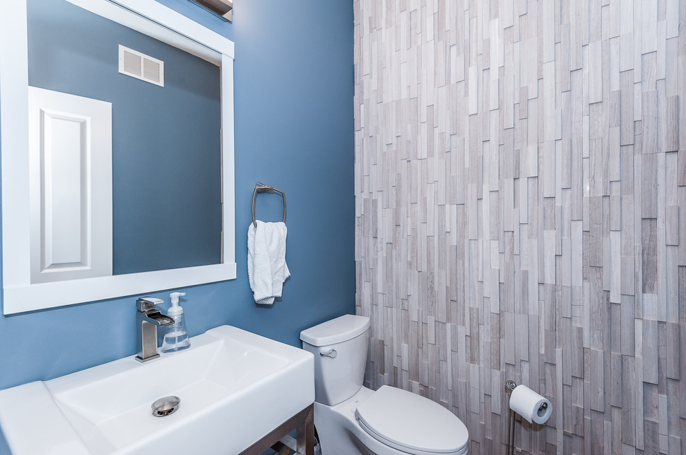 Inspiration for a small transitional dark wood floor and brown floor bathroom remodel in Other with a two-piece toilet and blue walls