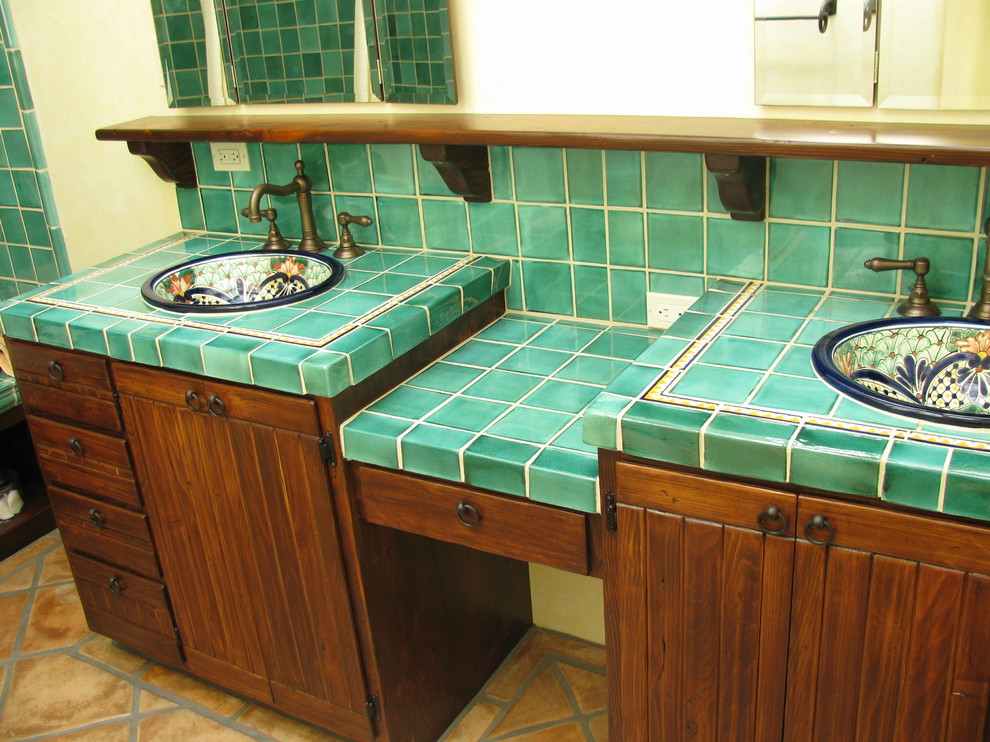 Example of a tuscan green tile and ceramic tile ceramic tile alcove bathtub design in San Diego with a drop-in sink and tile countertops