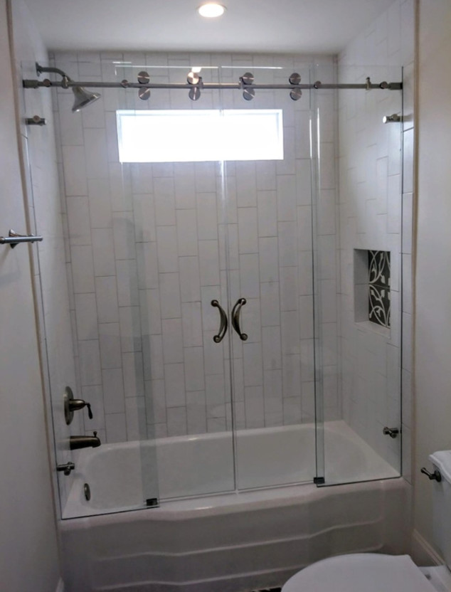 Medium sized classic ensuite bathroom in New Orleans with an alcove bath, a shower/bath combination, white tiles, metro tiles, white walls, porcelain flooring, white floors and a sliding door.