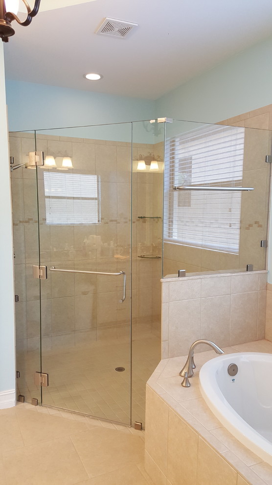 Contemporary bathroom in Miami with a corner shower and a hinged door.