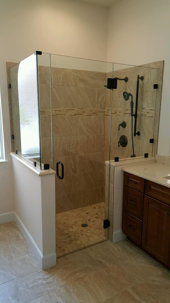 Photo of a contemporary bathroom in Miami with a corner shower and a hinged door.