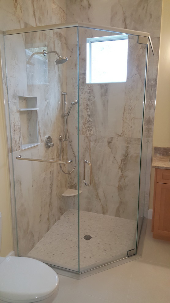 Contemporary bathroom in Miami with a corner shower and a hinged door.