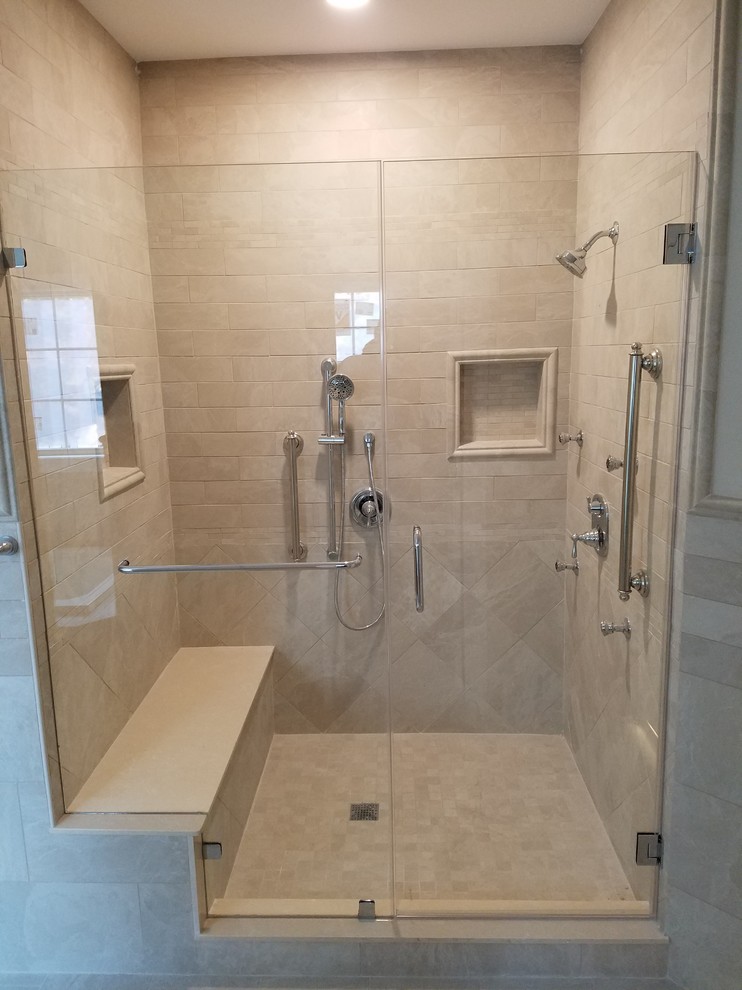 Example of a mid-sized trendy master beige tile and marble tile ceramic tile and white floor alcove shower design in New York with white walls and a hinged shower door