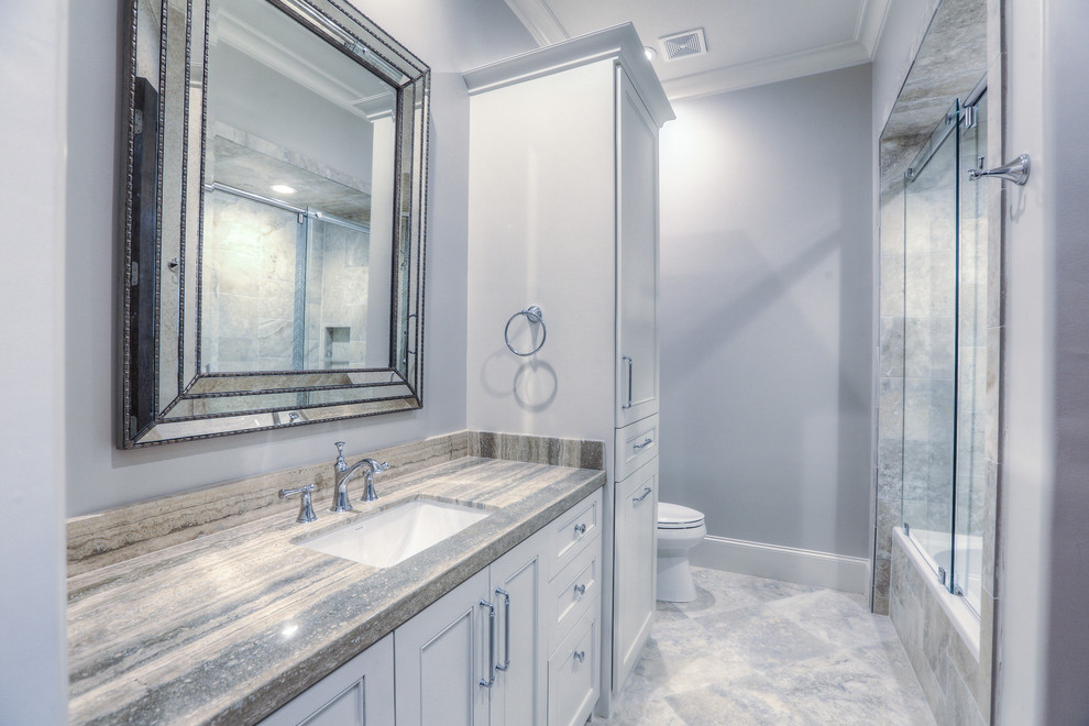 Large classic ensuite bathroom in Houston with shaker cabinets, white cabinets, an alcove bath, a shower/bath combination, a two-piece toilet, purple walls, marble flooring, a submerged sink, white floors and a sliding door.