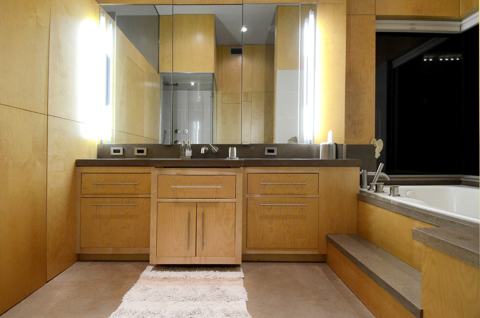 Large trendy master concrete floor, beige floor and single-sink bathroom photo in Baltimore with flat-panel cabinets, an integrated sink, a hinged shower door, light wood cabinets, a one-piece toilet, concrete countertops, gray countertops and a built-in vanity