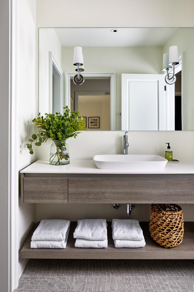 Inspiration for a medium sized bathroom in DC Metro with flat-panel cabinets, grey cabinets, a walk-in shower, a one-piece toilet, white tiles, porcelain tiles, white walls, porcelain flooring, an integrated sink, engineered stone worktops, multi-coloured floors, an open shower and white worktops.