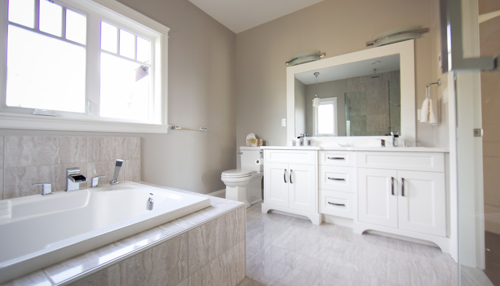 Inspiration for a timeless master beige tile bathroom remodel in Vancouver with shaker cabinets, white cabinets, a two-piece toilet, beige walls and an undermount sink