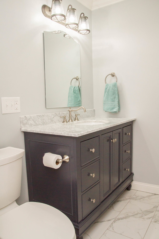 This is an example of a small classic shower room bathroom in Louisville with a two-piece toilet, beige tiles, grey walls, a submerged sink, marble worktops, recessed-panel cabinets, dark wood cabinets, an alcove bath, a shower/bath combination, ceramic tiles, marble flooring, white floors and a shower curtain.