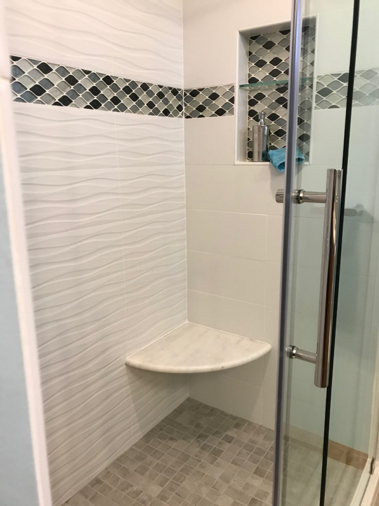 Medium sized classic ensuite bathroom in Other with raised-panel cabinets, medium wood cabinets, an alcove shower, white tiles, ceramic tiles, blue walls, porcelain flooring, a submerged sink, engineered stone worktops, grey floors, a sliding door, grey worktops, a wall niche, double sinks and a built in vanity unit.
