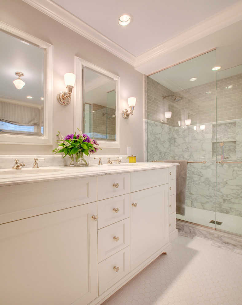 This is an example of a classic bathroom in Seattle with a submerged sink, recessed-panel cabinets, white cabinets, marble worktops, a freestanding bath, a corner shower, white tiles, stone tiles, white walls and ceramic flooring.
