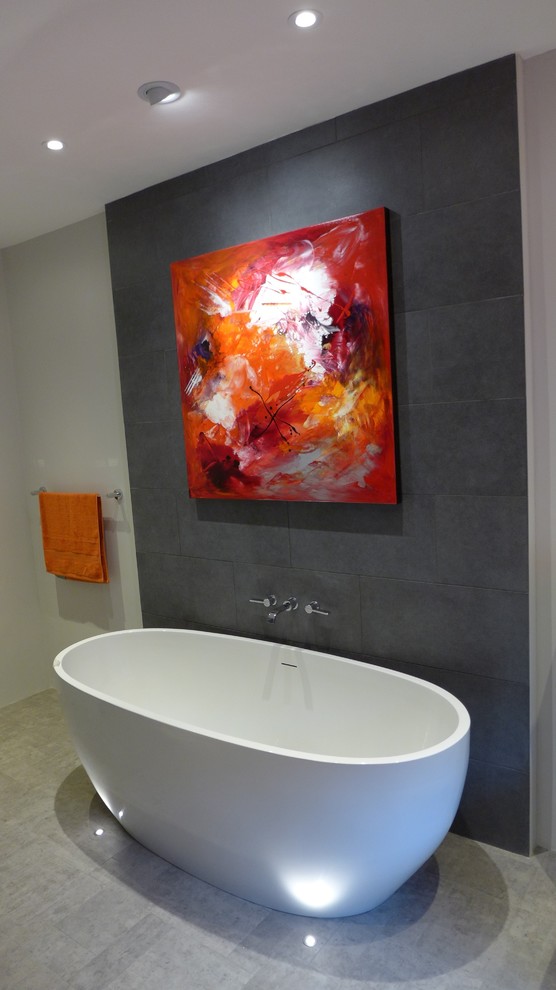 freestanding bath with grey tiled feature wall Contemporary