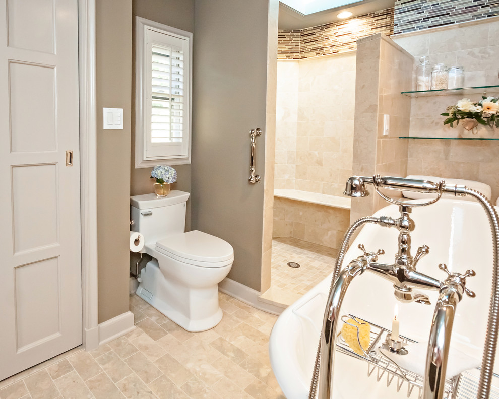 This is an example of a large traditional ensuite bathroom in New York with a freestanding bath, a walk-in shower, a one-piece toilet, beige tiles, beige walls, ceramic flooring, beige floors and an open shower.