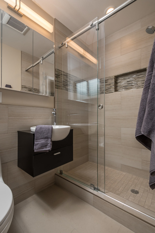 Photo of a small contemporary ensuite bathroom in San Francisco with dark wood cabinets, an alcove shower, a two-piece toilet, beige tiles, porcelain tiles, beige walls, porcelain flooring and a vessel sink.