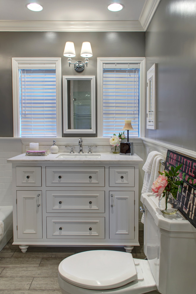 Example of a mid-sized classic master white tile and ceramic tile porcelain tile bathroom design in Los Angeles with an undermount sink, white cabinets, marble countertops, gray walls, a two-piece toilet and recessed-panel cabinets