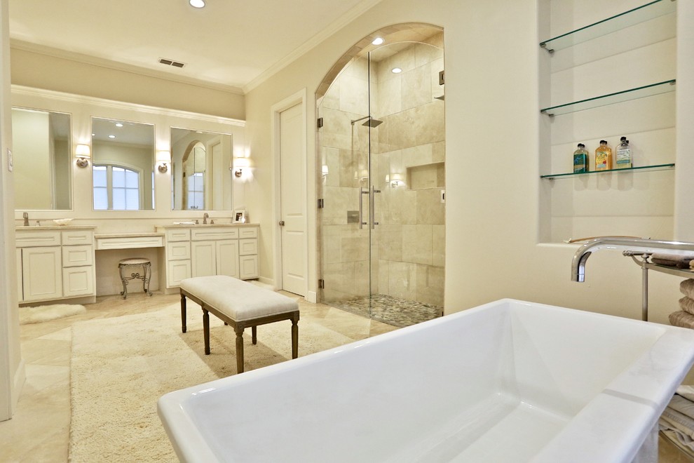 Свежая идея для дизайна: большая главная ванная комната в классическом стиле с врезной раковиной, фасадами с выступающей филенкой, белыми фасадами, мраморной столешницей, отдельно стоящей ванной, двойным душем, унитазом-моноблоком, бежевой плиткой, каменной плиткой, белыми стенами и полом из известняка - отличное фото интерьера