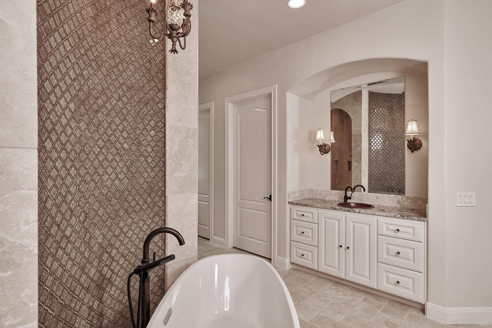 Mid-sized master bathroom in Austin with shaker cabinets, distressed cabinets, a freestanding tub, an open shower, a two-piece toilet, white tile, ceramic tile, beige walls, ceramic floors, a vessel sink, granite benchtops, grey floor, an open shower and multi-coloured benchtops.