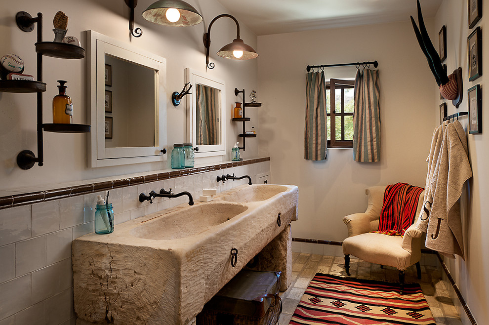 На фото: ванная комната среднего размера в стиле рустика с бежевыми стенами, кирпичным полом, столешницей из дерева, монолитной раковиной и зеркалом с подсветкой с