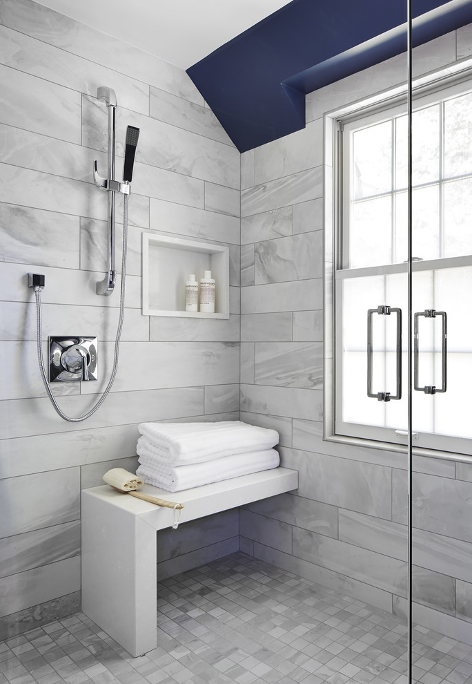 This is an example of a medium sized traditional ensuite bathroom in Minneapolis with medium wood cabinets, white tiles, blue walls, flat-panel cabinets, a corner shower, a two-piece toilet, stone tiles, marble flooring, a submerged sink and engineered stone worktops.