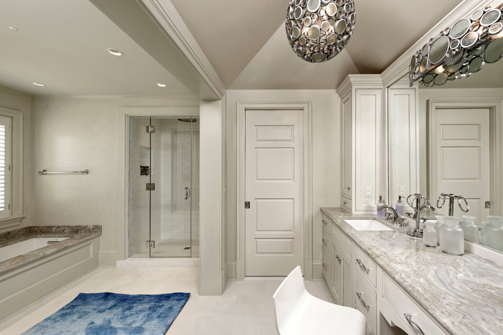 Photo of an expansive classic family bathroom in DC Metro with beaded cabinets, light wood cabinets, a built-in bath, an alcove shower, a one-piece toilet, grey tiles, mosaic tiles, grey walls, limestone flooring, a submerged sink, marble worktops, white floors and a hinged door.