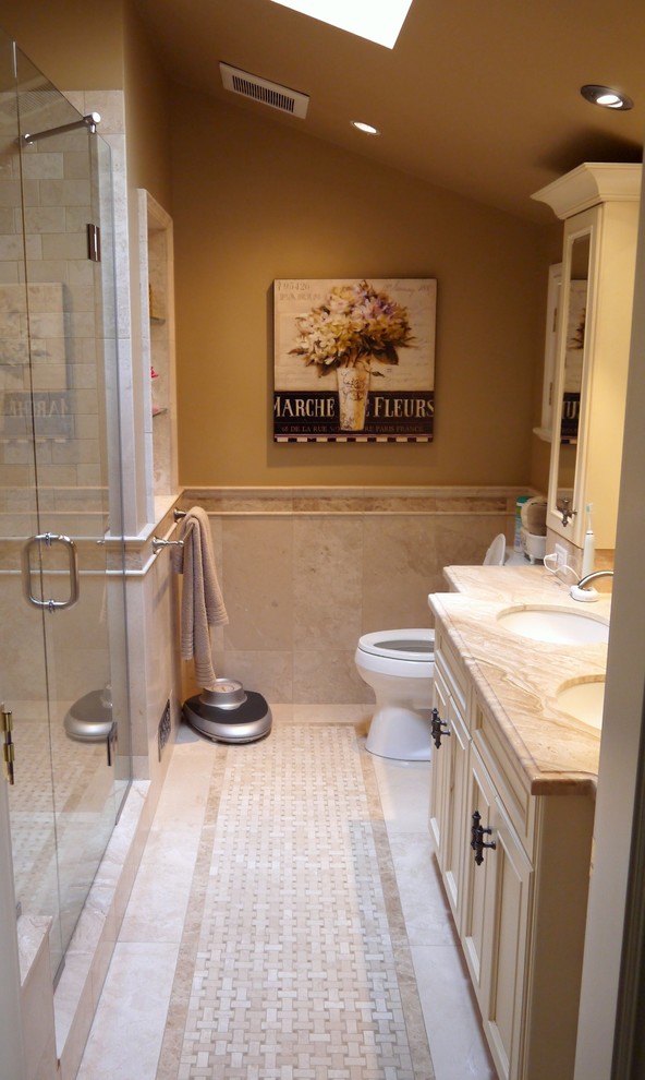 Example of a small classic master beige tile and stone tile marble floor alcove shower design in Vancouver with an undermount sink, beige cabinets, marble countertops, beige walls and recessed-panel cabinets
