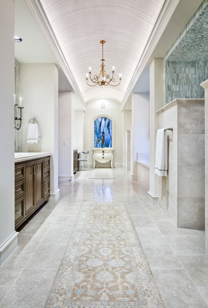 Expansive mediterranean ensuite bathroom in Austin with recessed-panel cabinets, medium wood cabinets and an alcove bath.