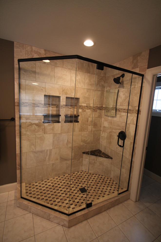 Design ideas for a large modern ensuite bathroom in Minneapolis with raised-panel cabinets, white cabinets, a corner shower, brown walls, travertine flooring, a submerged sink, marble worktops, beige floors, a hinged door and brown worktops.
