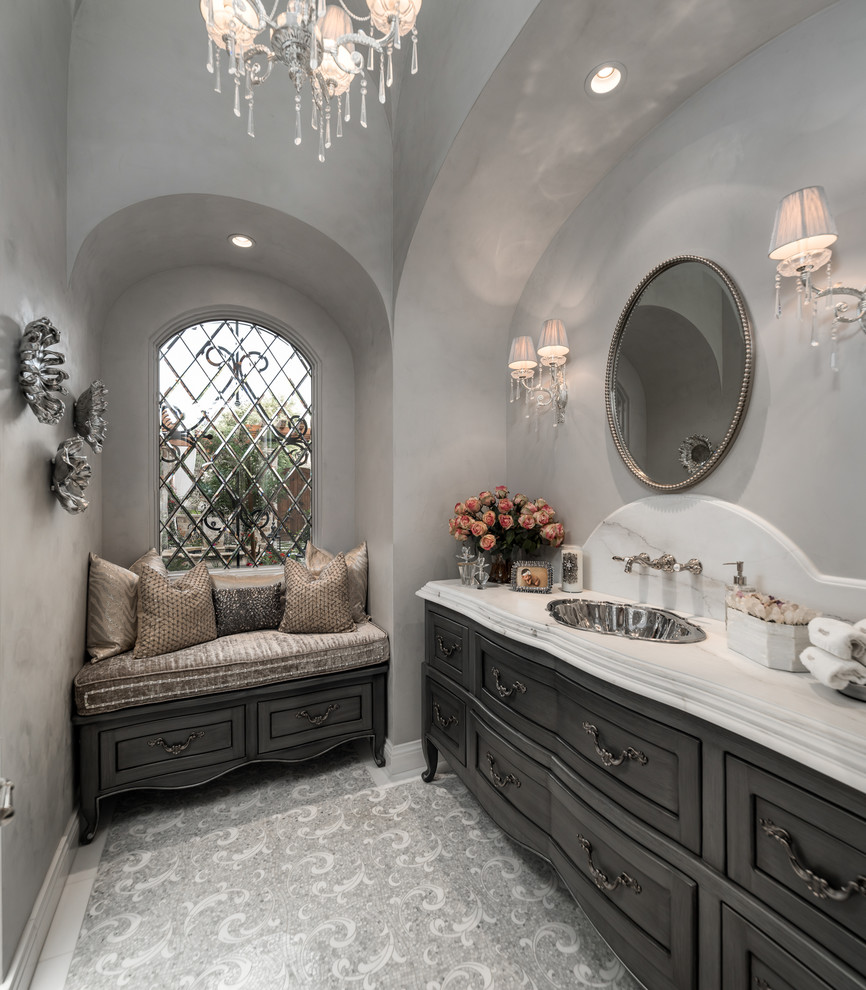 Идея дизайна: огромная главная ванная комната в стиле шебби-шик с фасадами островного типа, серыми фасадами, отдельно стоящей ванной, душем в нише, унитазом-моноблоком, разноцветной плиткой, керамогранитной плиткой, белыми стенами, полом из керамогранита, накладной раковиной, мраморной столешницей, разноцветным полом, душем с распашными дверями и разноцветной столешницей