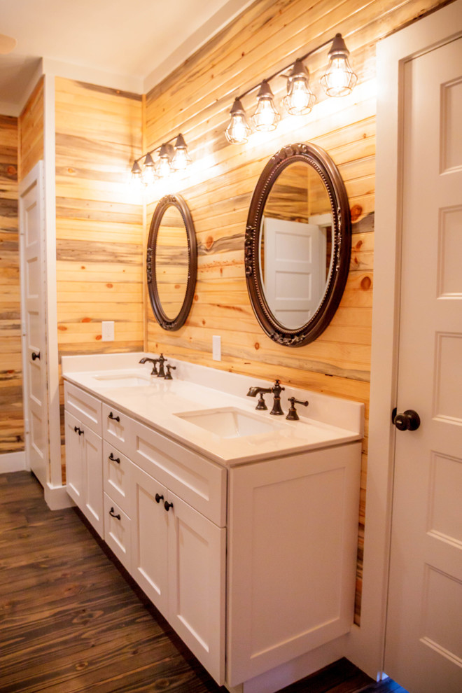 This is an example of a medium sized farmhouse ensuite bathroom in Houston with shaker cabinets, white cabinets, brown walls, dark hardwood flooring, a submerged sink, engineered stone worktops, brown floors, an alcove shower, a hinged door and white tiles.