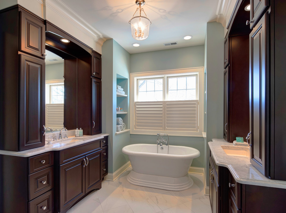 Inspiration for a large transitional white tile and porcelain tile porcelain tile bathroom remodel in Chicago with an undermount sink, raised-panel cabinets, dark wood cabinets, marble countertops, a two-piece toilet and green walls