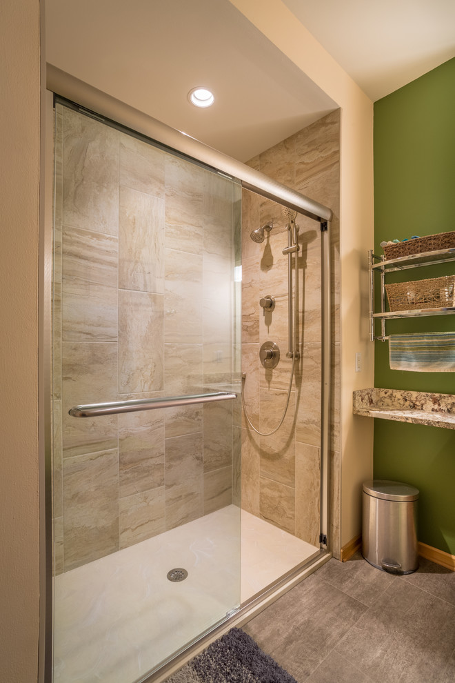 Photo of a small classic shower room bathroom in Other with shaker cabinets, medium wood cabinets, an alcove shower, a one-piece toilet, beige tiles, ceramic tiles, green walls, laminate floors, a submerged sink, quartz worktops, grey floors, a sliding door and beige worktops.