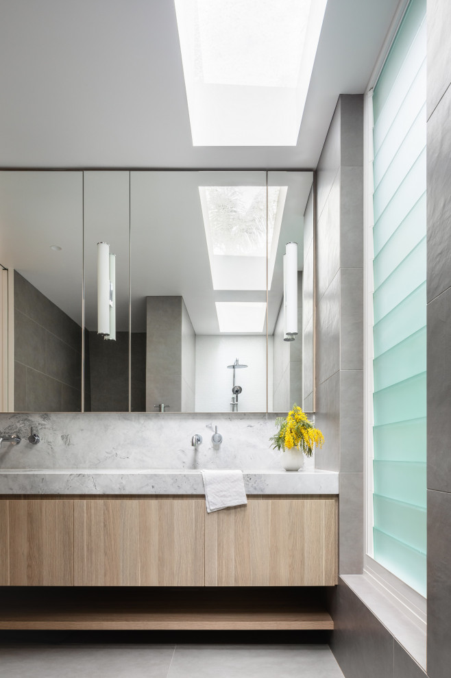 Inspiration for a large contemporary bathroom in Sydney with light wood cabinets, a submerged sink, granite worktops, an open shower, double sinks and a built in vanity unit.