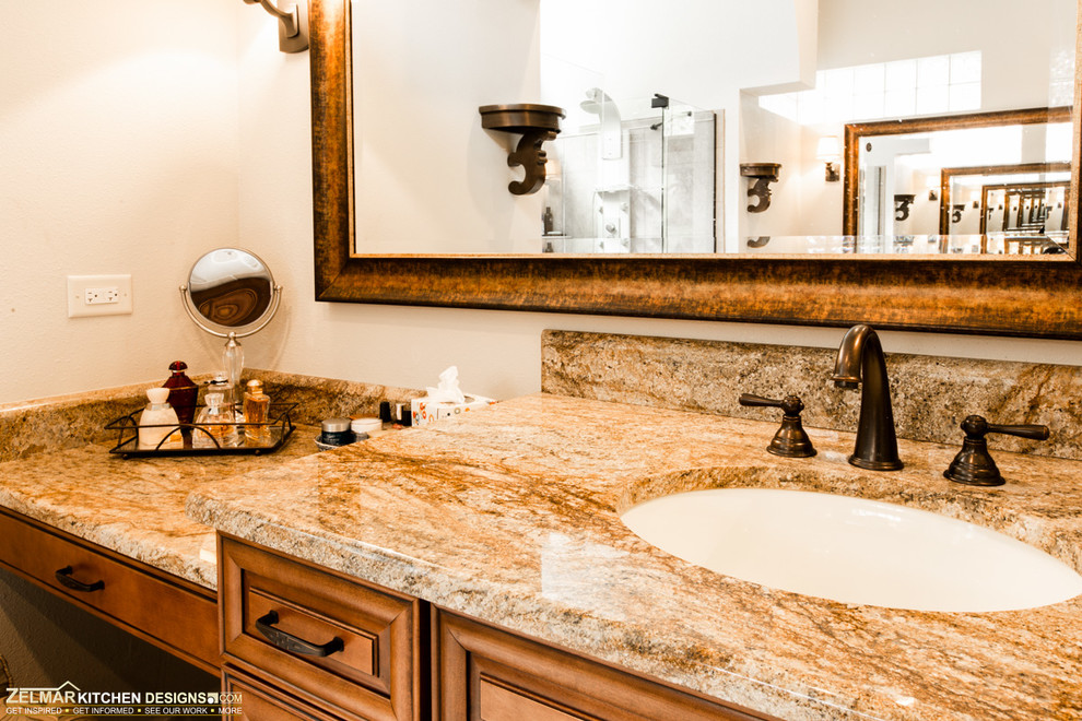 Inspiration for a large timeless master beige tile and stone tile travertine floor doorless shower remodel in Orlando with an undermount sink, raised-panel cabinets, medium tone wood cabinets and granite countertops