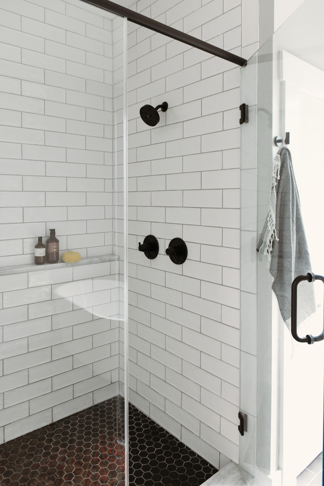 Photo of a small contemporary ensuite bathroom in Other with shaker cabinets, light wood cabinets, a freestanding bath, a walk-in shower, white tiles, metro tiles, porcelain flooring, a submerged sink, quartz worktops, black floors, a hinged door and white worktops.