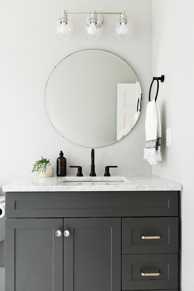 Design ideas for a small contemporary ensuite bathroom in Other with shaker cabinets, light wood cabinets, a freestanding bath, a walk-in shower, white tiles, metro tiles, porcelain flooring, a submerged sink, quartz worktops, black floors, a hinged door and white worktops.