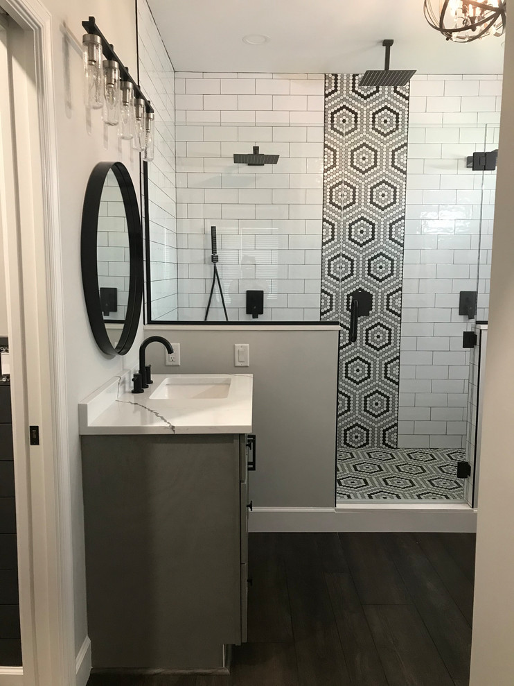 Inspiration for a large traditional ensuite bathroom in Baltimore with shaker cabinets, grey cabinets, a double shower, a one-piece toilet, white tiles, ceramic tiles, grey walls, vinyl flooring, a submerged sink, engineered stone worktops, brown floors, a hinged door and white worktops.