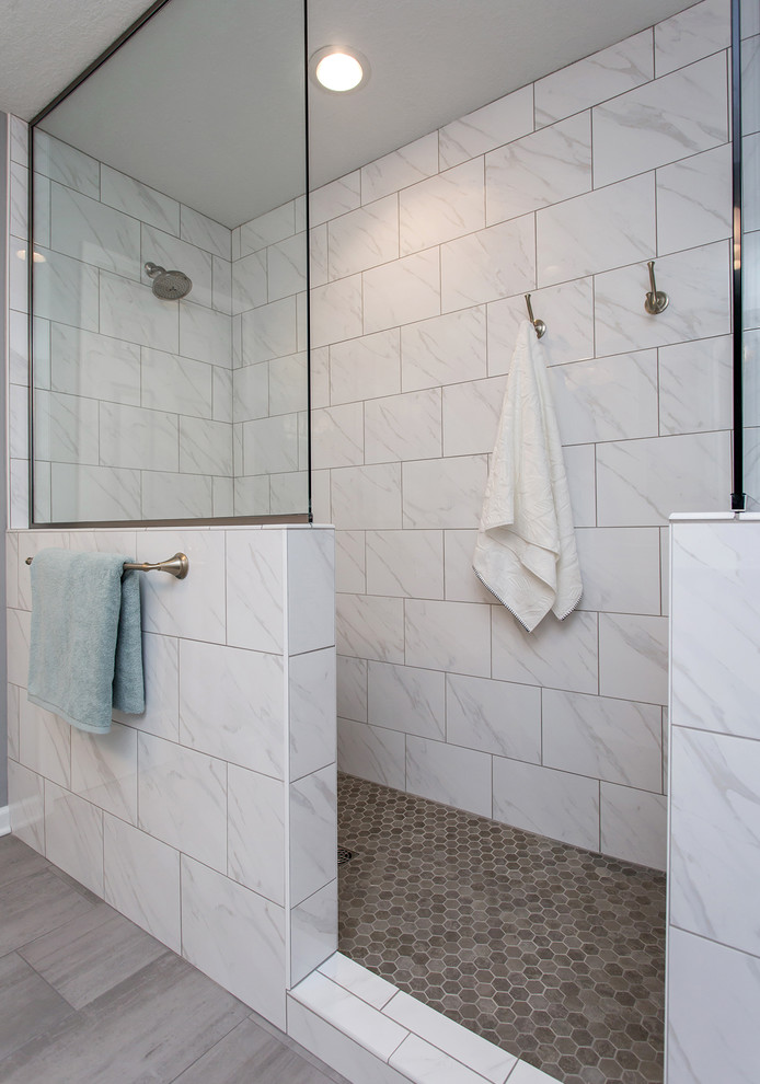 Inspiration for a mid-sized transitional master ceramic tile and gray floor bathroom remodel in Other with recessed-panel cabinets, white cabinets, a two-piece toilet, gray walls, an undermount sink, quartz countertops and white countertops