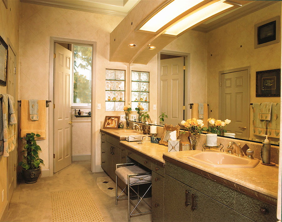 Inspiration for a large classic ensuite bathroom in Orange County with flat-panel cabinets, grey cabinets, engineered stone worktops, brown tiles, an alcove bath, a walk-in shower, a one-piece toilet, a built-in sink, beige walls, limestone flooring and beige floors.