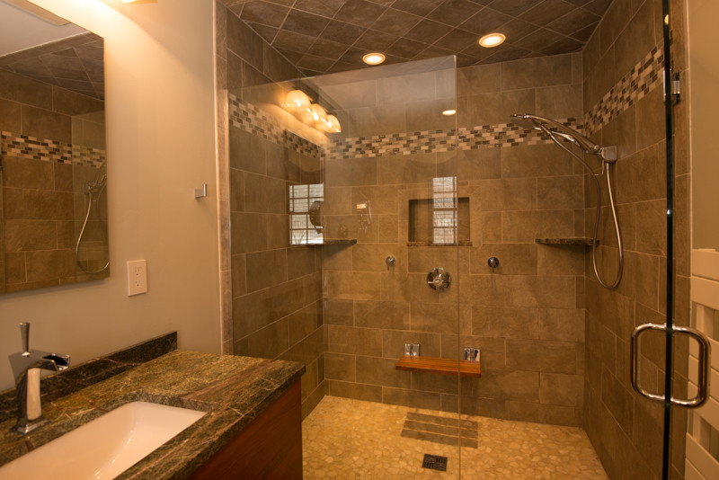 Inspiration for a contemporary master alcove shower remodel in Boston with an undermount sink, furniture-like cabinets, medium tone wood cabinets, granite countertops and a two-piece toilet