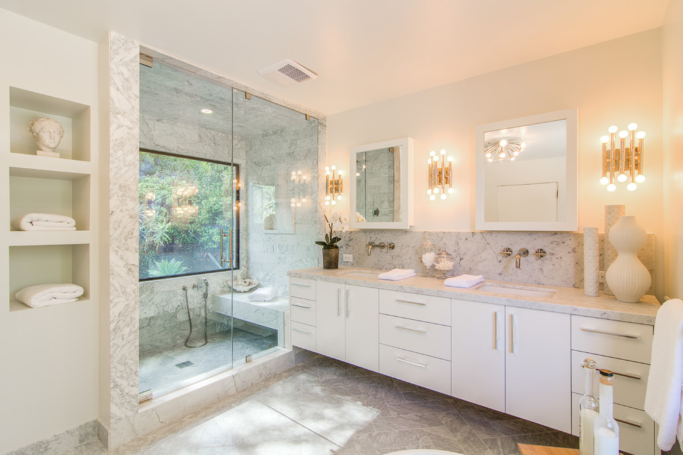 This is an example of a contemporary ensuite bathroom in Los Angeles with flat-panel cabinets, white cabinets, an alcove shower, grey tiles, white walls, a submerged sink, grey floors and a hinged door.