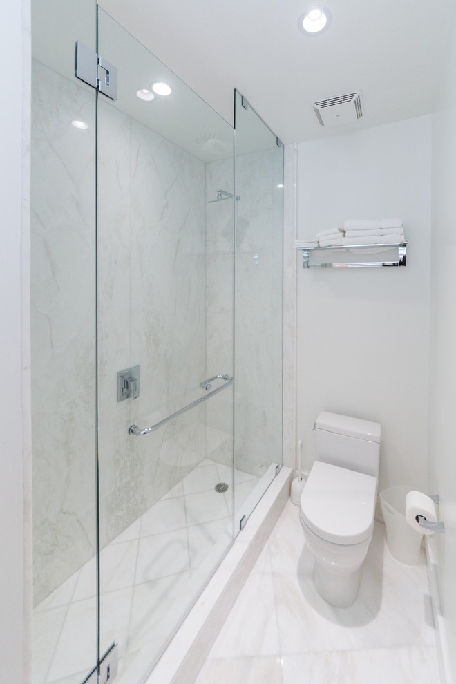 Mid-sized trendy 3/4 white tile and stone tile marble floor corner shower photo in Miami with a two-piece toilet and white walls